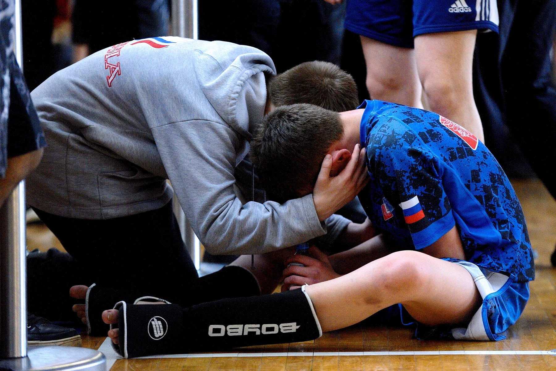 Coach supporting a young athlete after competition