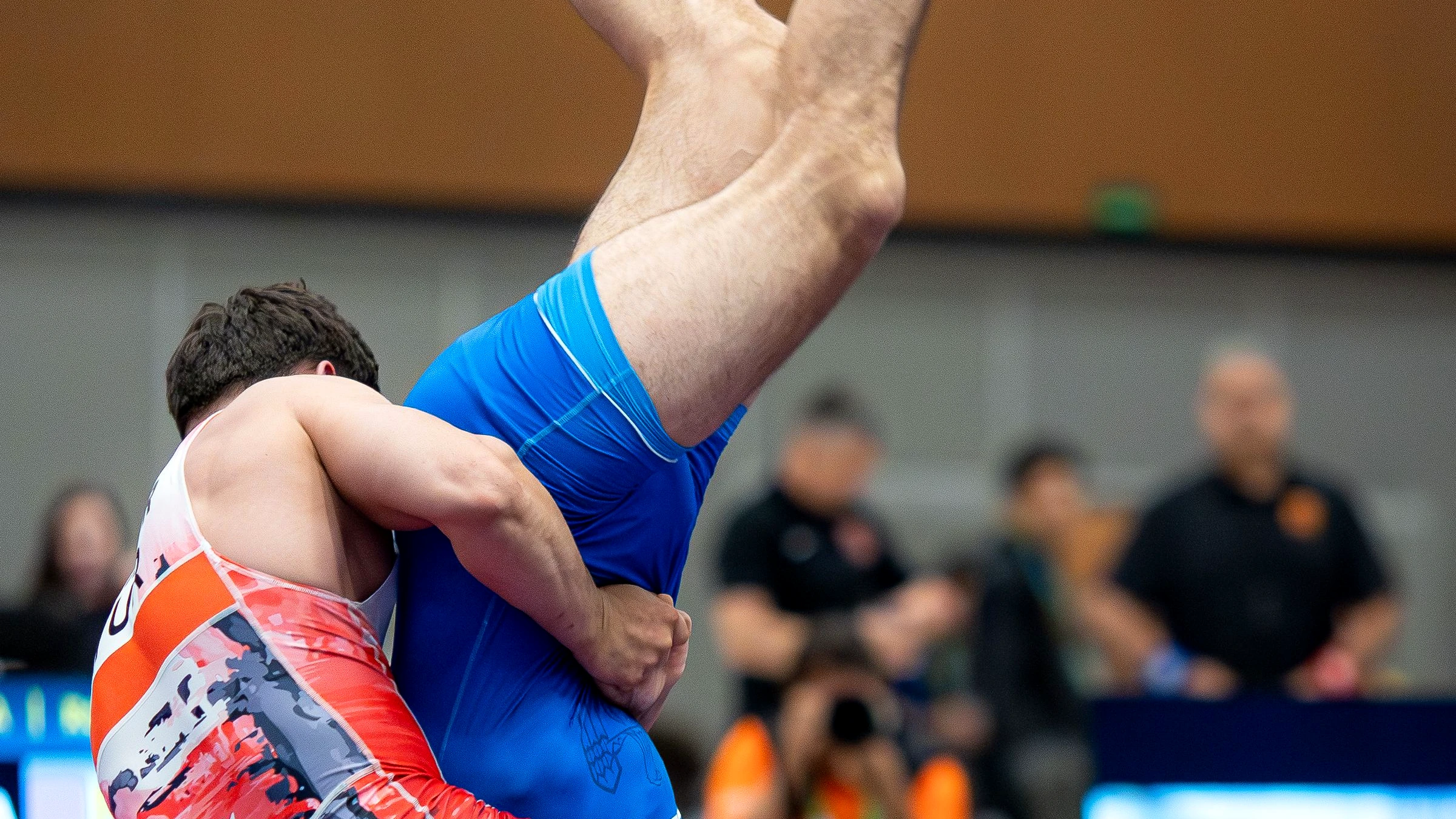 Freestyle wrestling action under competition lights