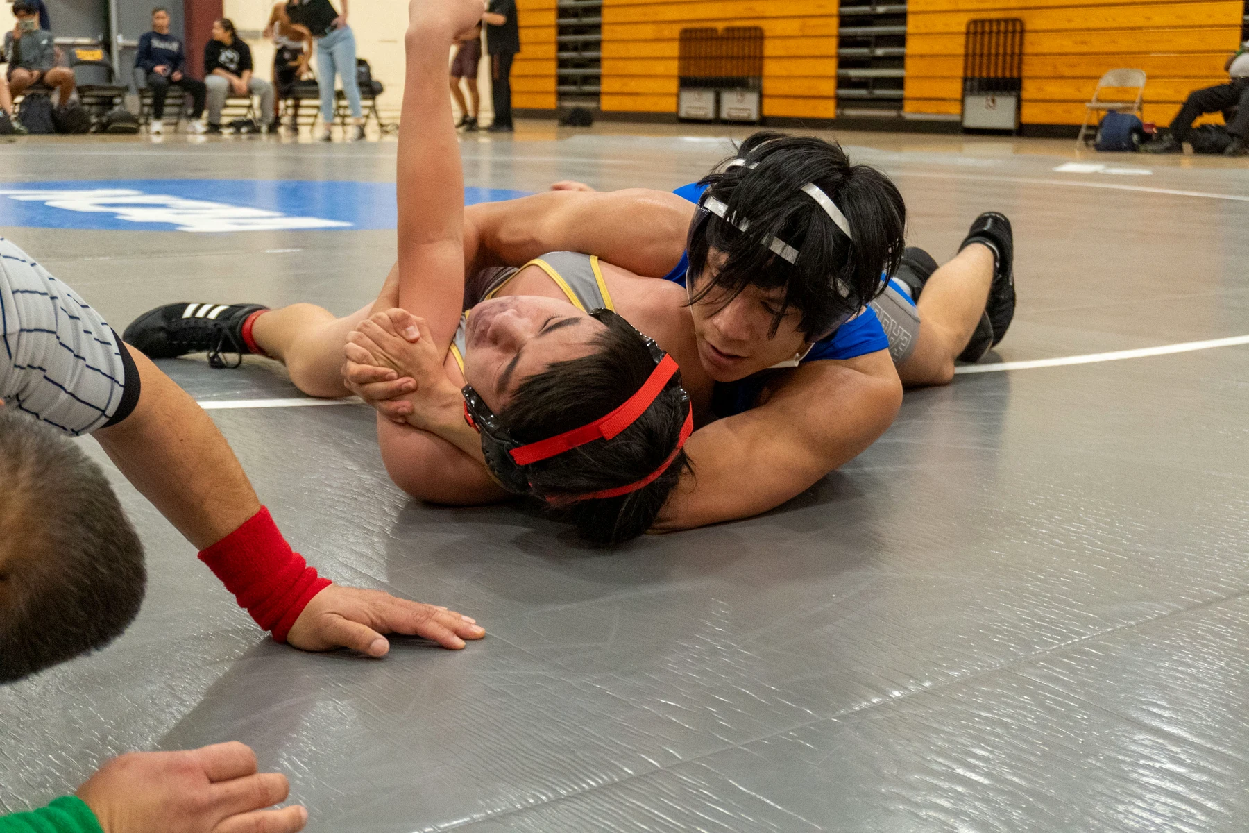 High school wrestlers competing on the mat