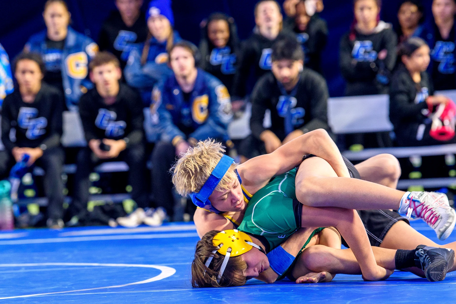 Youth wrestlers competing in a school gym